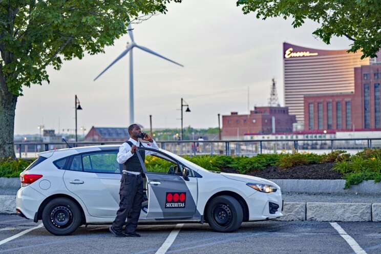 Mobile Guarding officer standing by his vehicle.