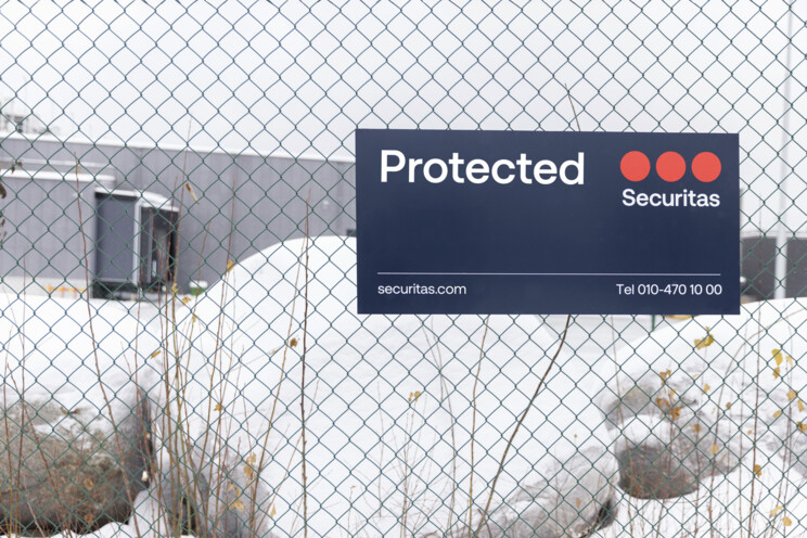 Securitas sign displaying the text, "Protected" on a gate.