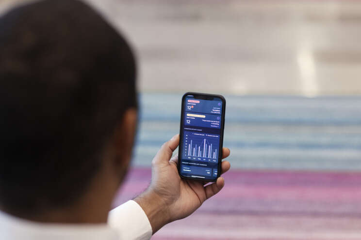 Alt text for image (max 125 characters): Person watching a statistics overview on a cell phone | Securitas USA